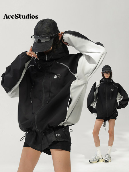 Model wearing a black and white sporty hooded jacket with black shorts