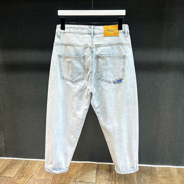 ພາກຮຽນ spring ແລະ summer ໃຫມ່ jeans ສີຟ້າອ່ອນຂອງຜູ້ຊາຍ retro ຍີ່ຫໍ້ trendy ກາງເກງວ່າງເກົ້າຈຸດບາດເຈັບແລະ harem tapered pants