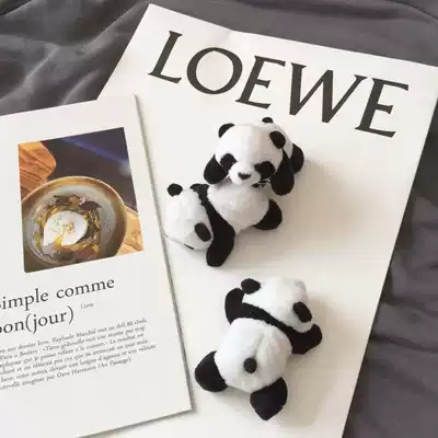 The cute panda lying on your body is a brooch.