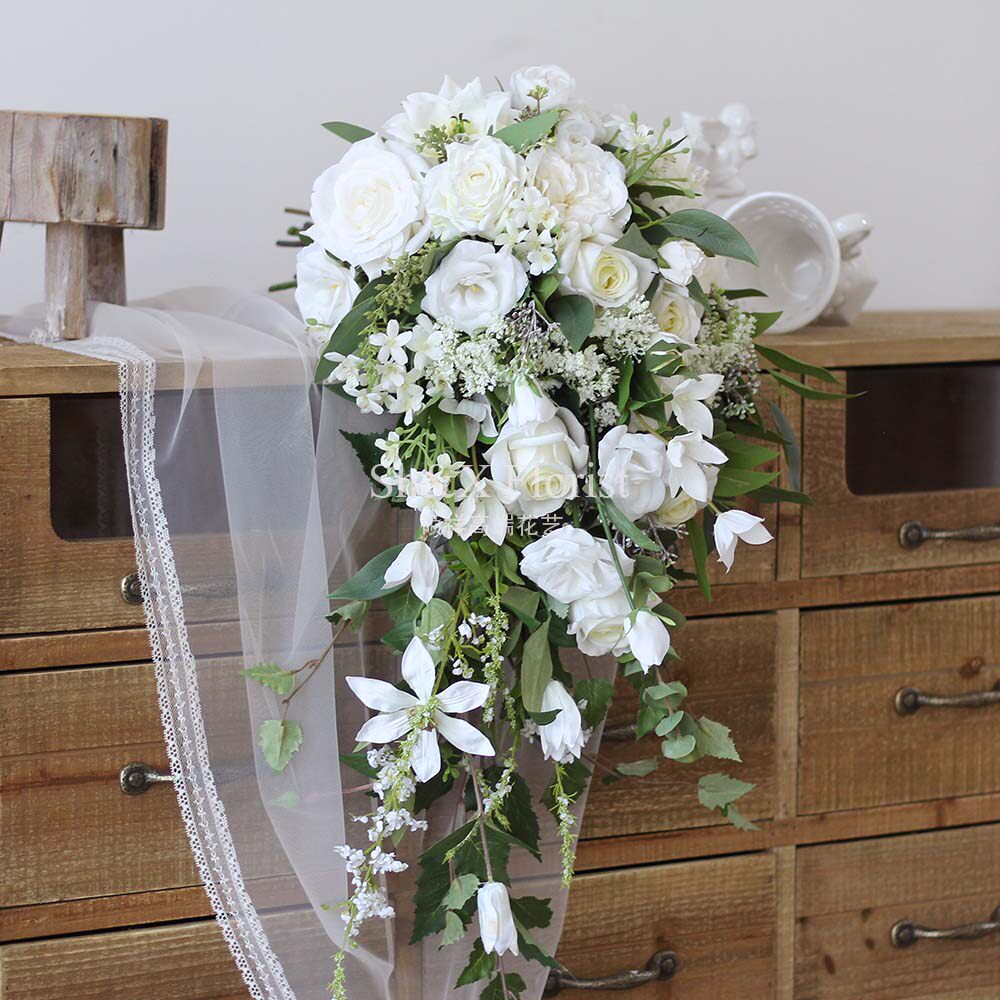 Emulated florist bride's hand holding flower fake florist with water drop type hand holding the flower brigade to shoot the props wedding decoration