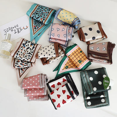 A variety of patterned clearance silk scarves for women can be used as hair bands to tie hair and bags