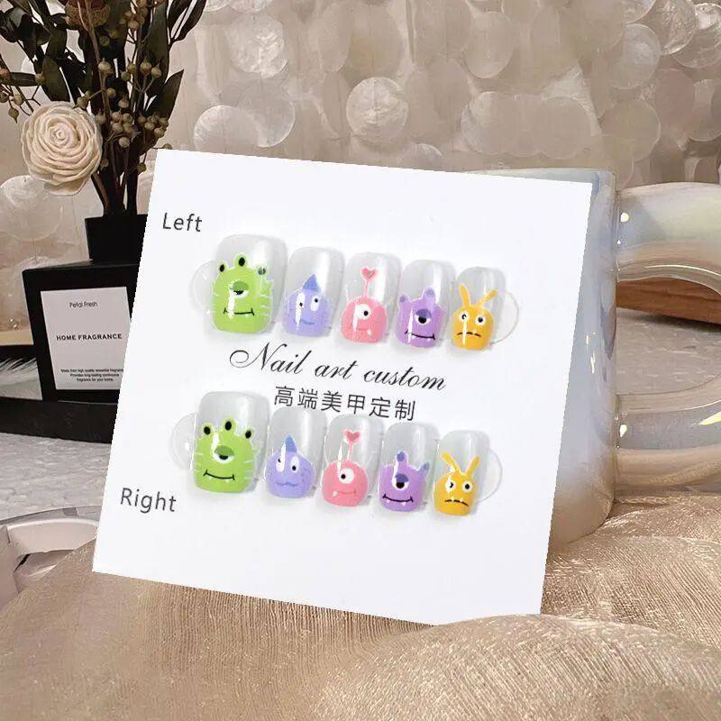 Handmade Children's Nail Art Wearable Short Cartoon Monster Cat-Eye Fake Nail Stickers 2026 New Model Handmade Children's Nail Art Wearable Short Cartoon Monster Cat-Eye Fake Nail Stickers 2026 New Model