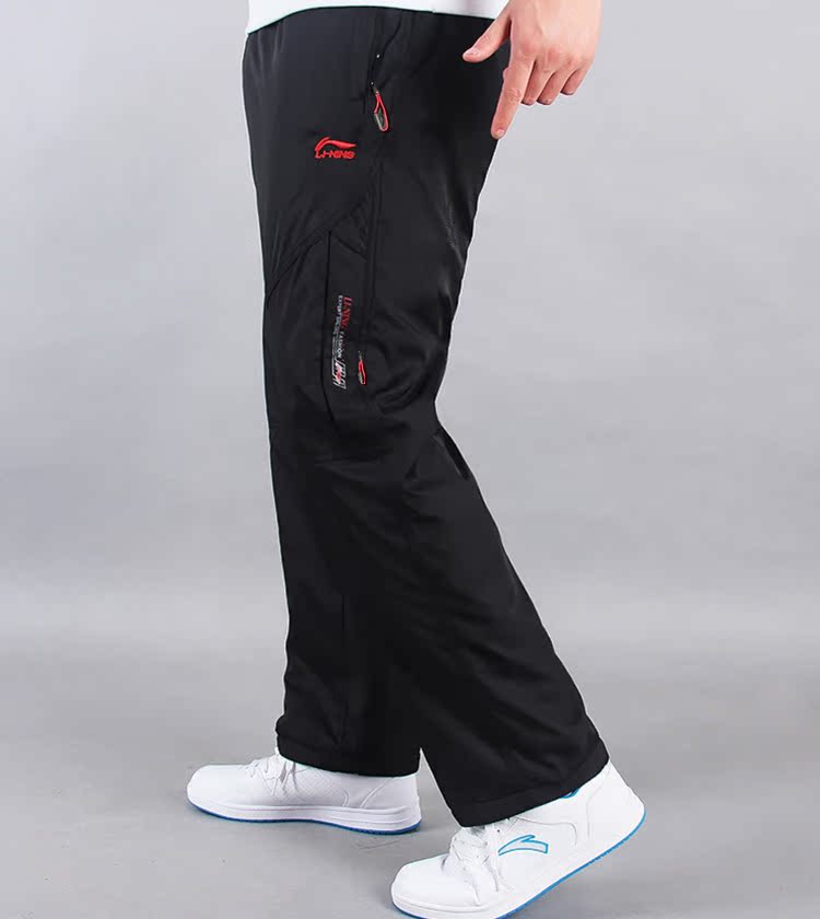 Li Ning mùa đông cộng với quần nhung nam rộng rãi dày ấm áp áo gió mưa lụa nam thể thao quần dài quần áo nam hàng hiệu