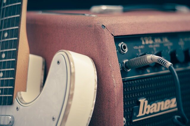 is playing guitar hard