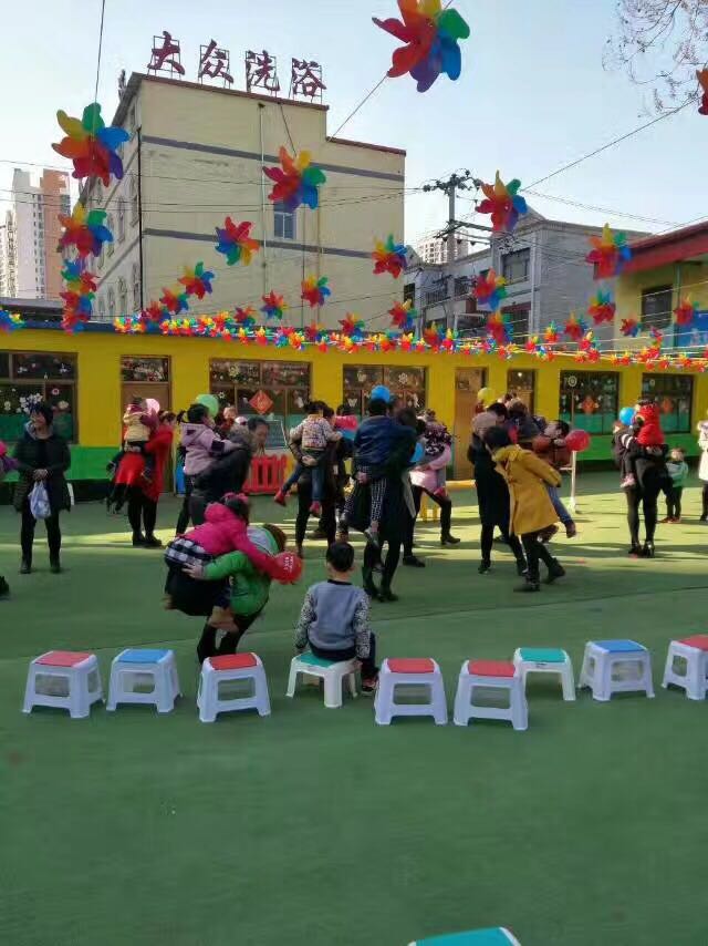 Kindergarten playground is decorated with colorful windmills in front of supermarket mall door - decorated windmill